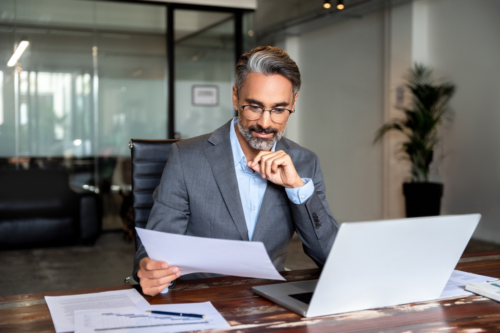 Indian male business man doing taxes for his client